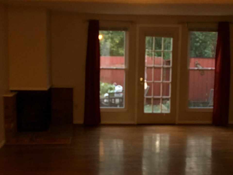 Living room with patio view and fireplace