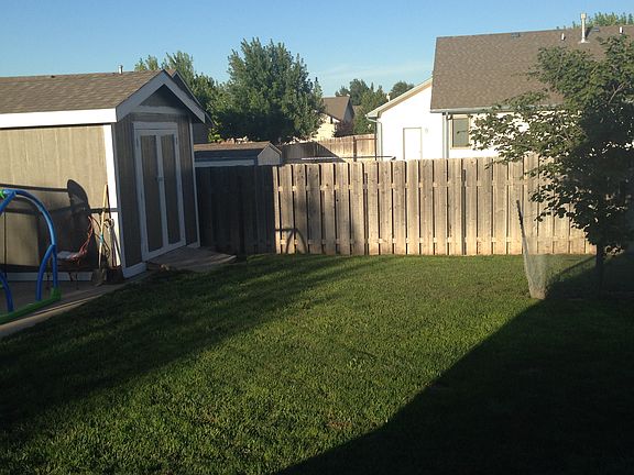 Fenced in backyard with shed