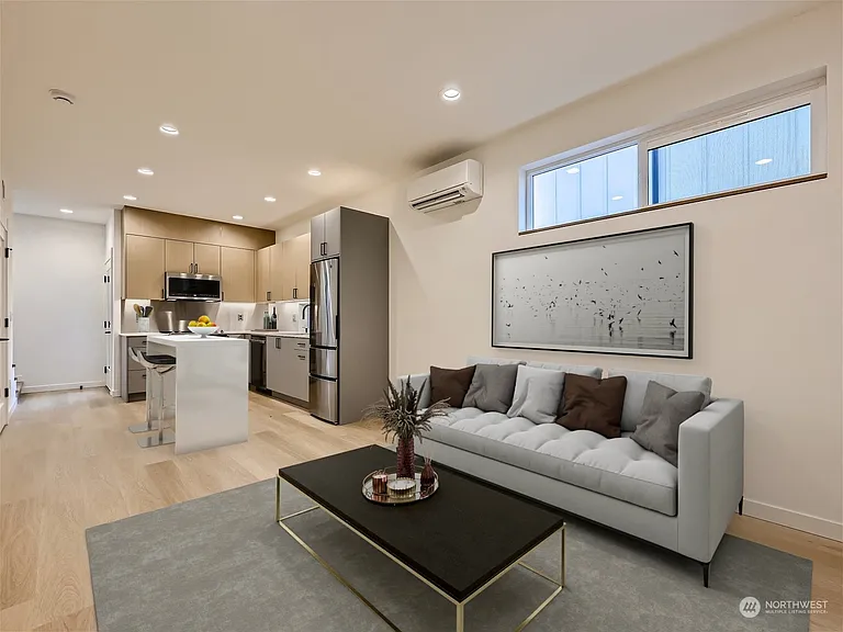 Living room. Ideal TV location is on opposite wall. Shelving has since been added for additional storage!