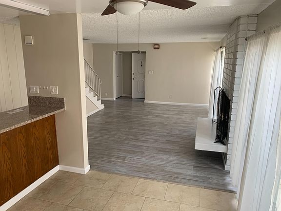 Living room area with two closets and a fire place.