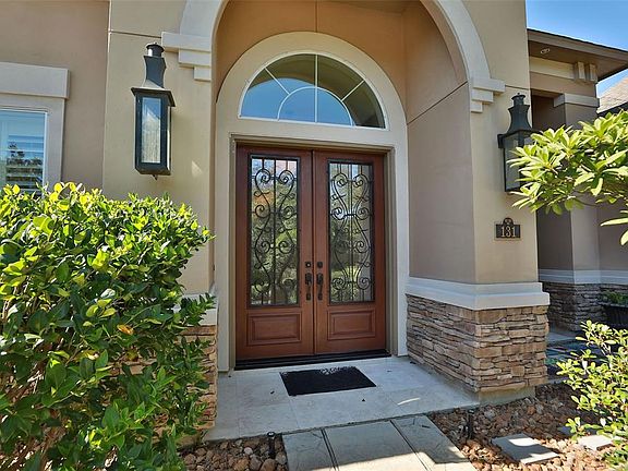 Stucco and stacked stone are neutral colors and the double front door opens to a fantastic entry....just wait!