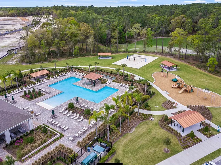 Resort style pool area with volleyball court, tot lot & covered picnic areas. Expansive indoor entertainment area with bathroom facilities & outdoor covered seating areas. Excellent space for family gatherings & weekend enjoyment! Staycation perfection!