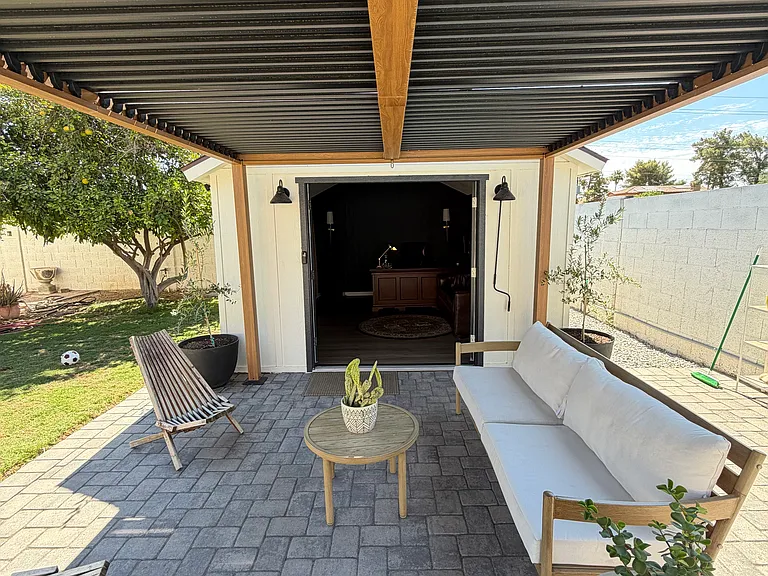 View from cover patio looking inside the detached office/studio (French doors open)