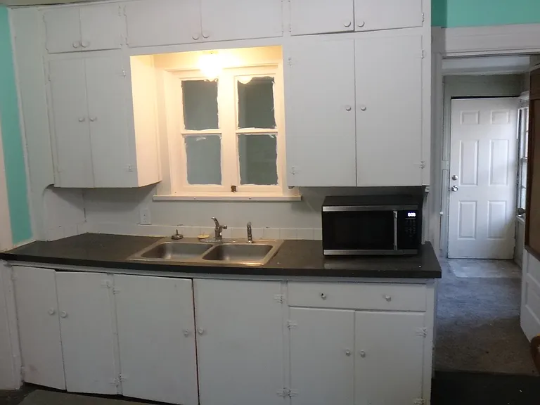 Kitchen with plent of storage! Also extra lighting and bar windows to bedroom.