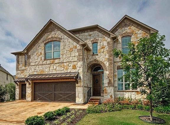 Located on a quiet cul-de-sac, this beautiful stone home fits the bill.