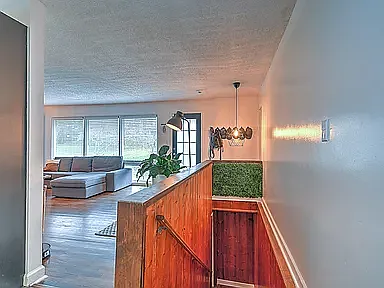 Stairs lead down to a spacious lounge, perfect for hosting late-night movies or game nights.