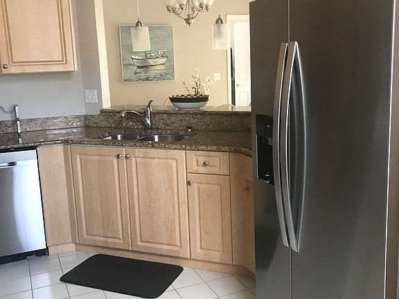 Refrigerator has water and ice dispensers on the door.