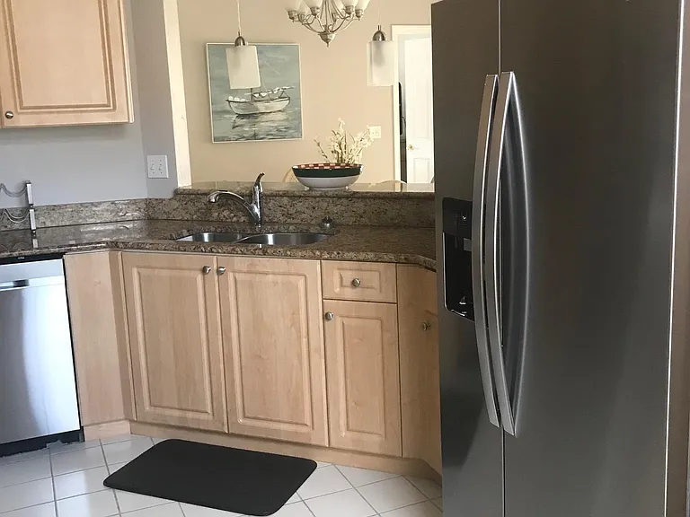 Refrigerator has water and ice dispensers on the door.