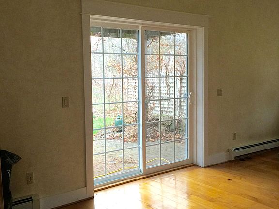 Hardwood floors throughout leading out to brick patio & Arbo