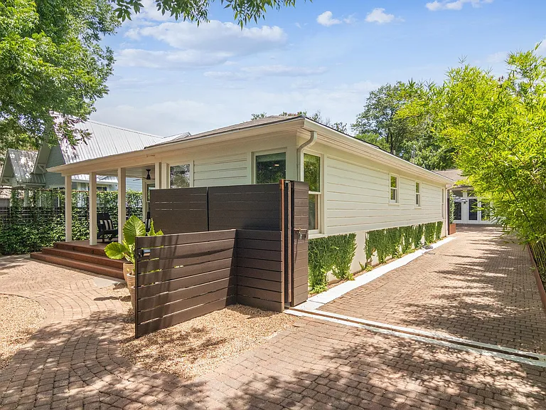 Front and side of house, cobblestone driveway and walkways, privacy fence, rolling gate closed 24/7.