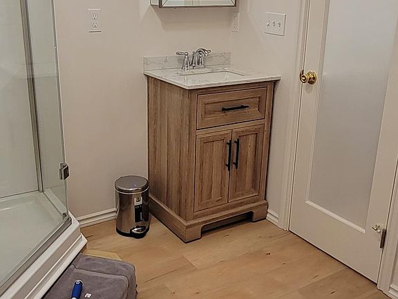 Bathroom and Dressing area. Closet for hanging clothes, 4 drawer dresser for folding clothes, plus extra room for storage .
Door opens to the kitchen area.