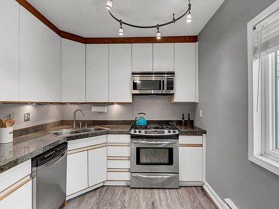 Kitchen with granite counters, dishwasher, microwave