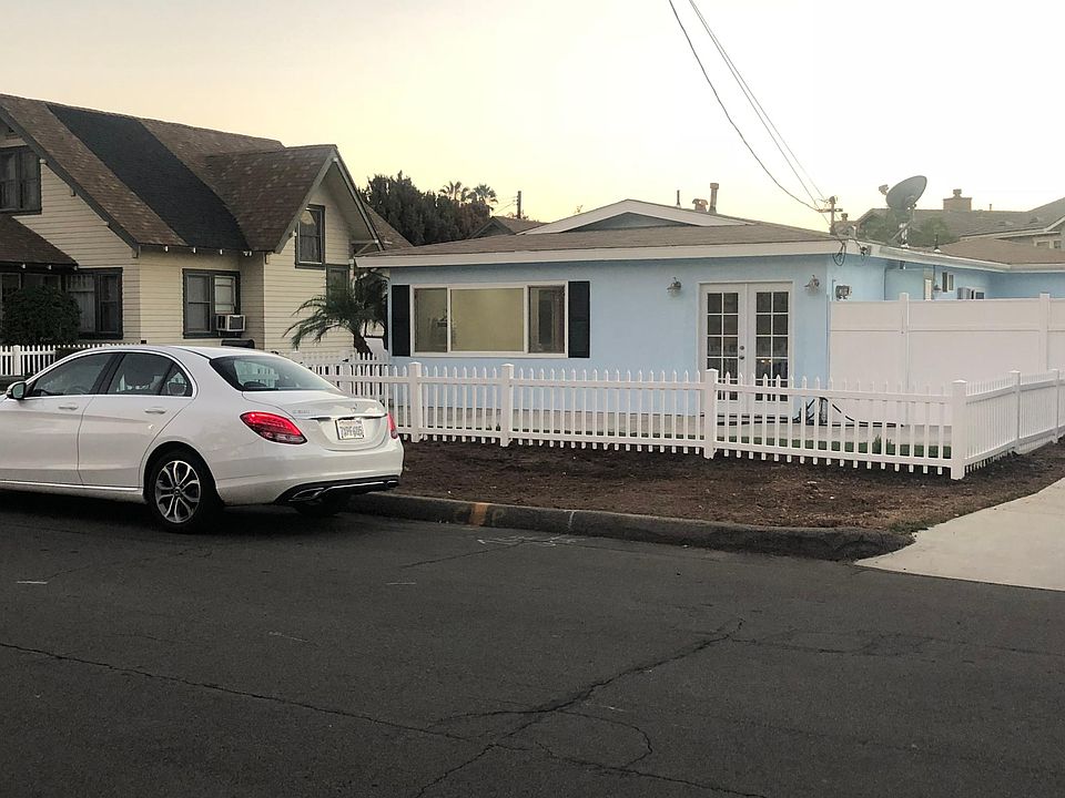 Front of house with street parking. Front yard and separate side yard to the right.
