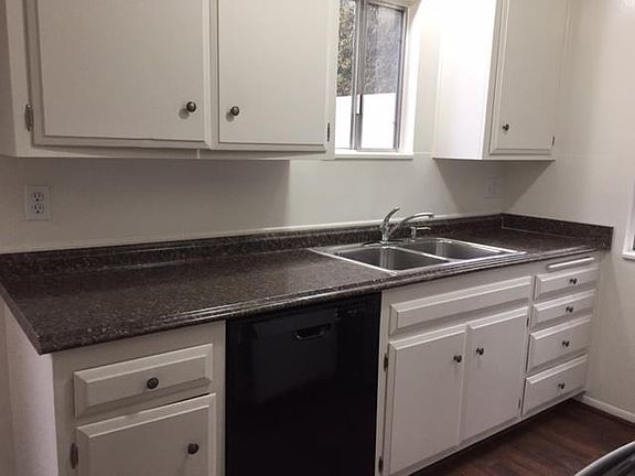 Light and airy kitchen with window over sink; dishwasher