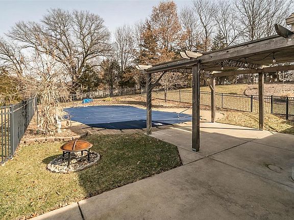 Charming pergola overlooking the large pool area and gardens.