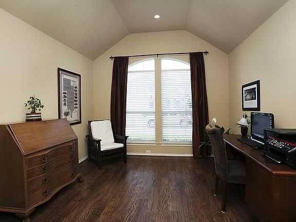 Dining room with laminate flooring and views of the street. Currently being used as an office. LED l