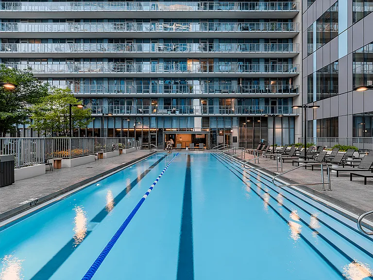 Take a dip in our stunning pool, surrounded by modern architecture and cozy lounge chairs