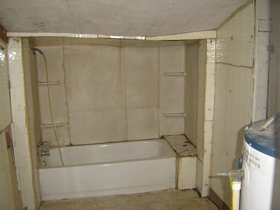 Bathroom needs to be redone.  The ceiling is sloping with the pitch of the roof, this is not collapsing