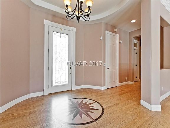 Custom floor medallion in entry way. Engineered hardwood floors throughout house.