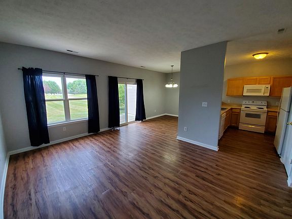 LIVING ROOM W/ VIEWS OF KITCHEN AND DINING ROOM