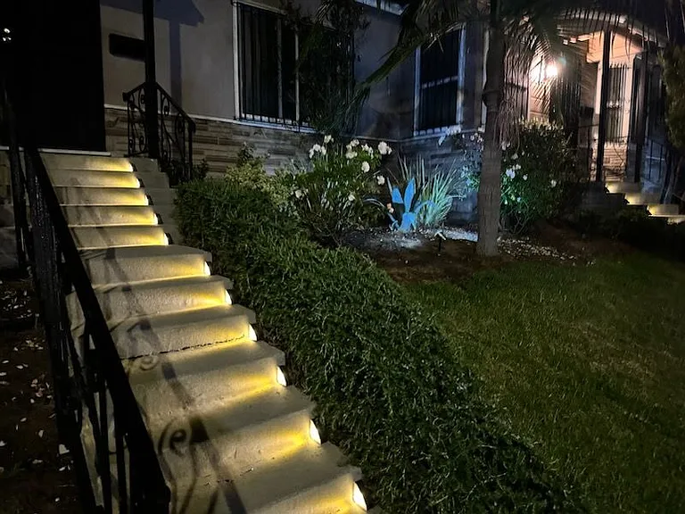This duplex is brightly illuminated showcasing the landscape.