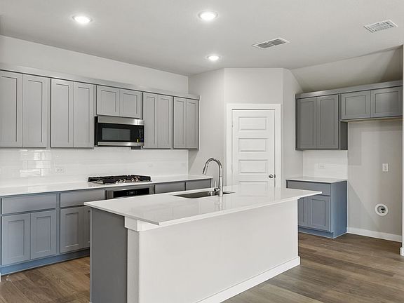 Kitchen in the Emmy II home plan by Trophy Signature Homes - REPRESENTATIVE PHOTO