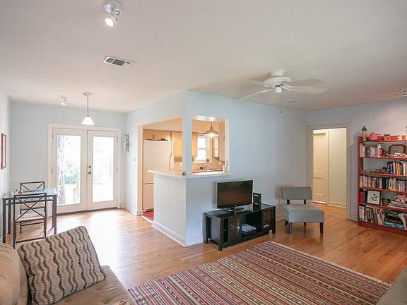Living room and kitchen. French doors to backyard. Door on t