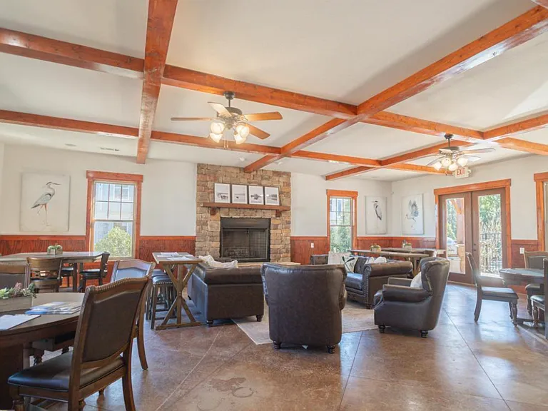 Clubhouse with lots of seating and a fireplace