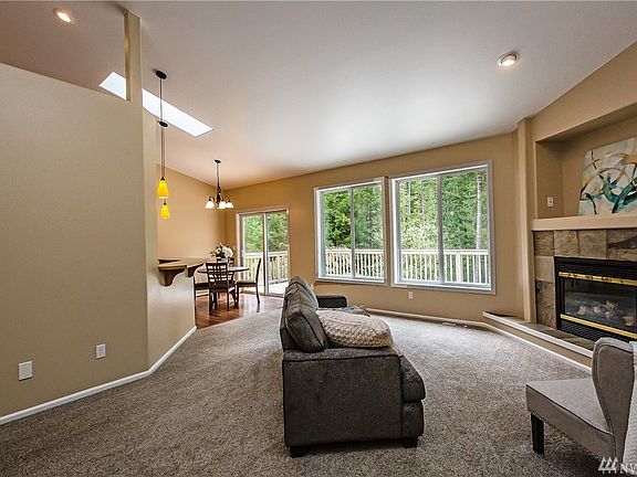 The living room has a natural gas fireplace and is off of the kitchen/dining area.  The carpeting throughout the home is brand new.