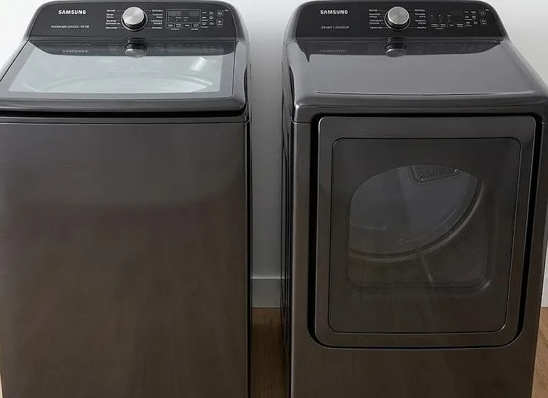 Dedicated laundry area with side-by-side washer and dryer for convenient in-home laundry access.