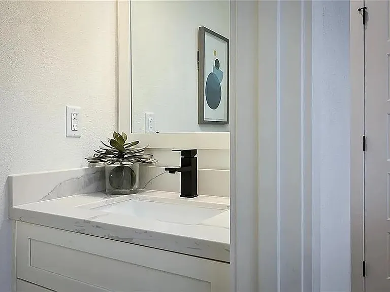 Elegant main-level powder bath with modern vanity, designer fixtures, and contemporary finishes.

Photos are representative and finishes or layouts may vary slightly by unit.