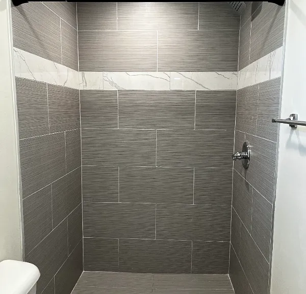 Updated bathroom with stone shower and window.