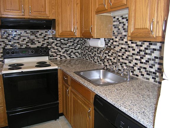 Updated kitchen with granite counters and tile backsplash