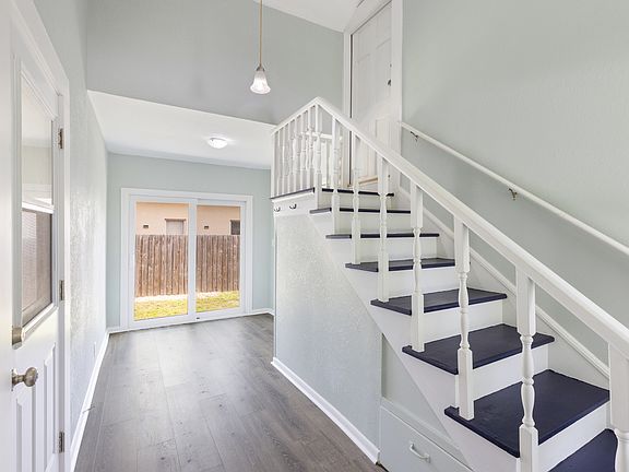 Shared common area with access to both apartments, on-site laundry, and a fenced backyard.