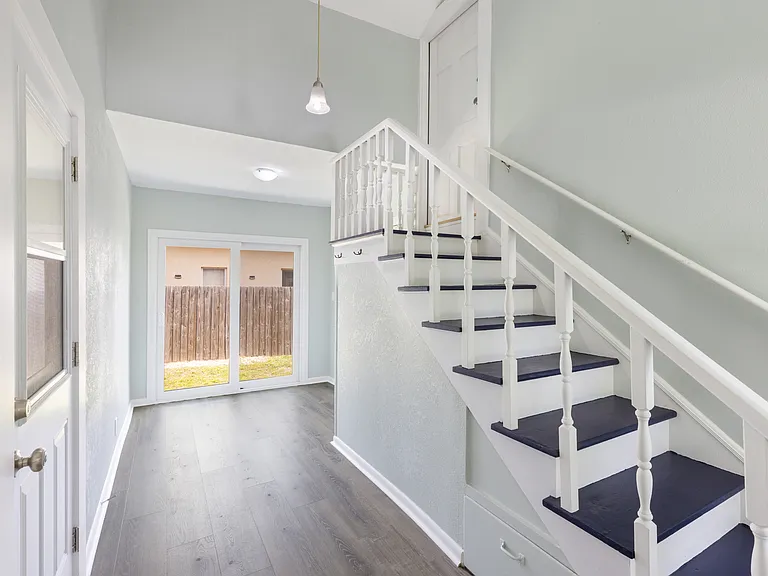 Shared common area with access to both apartments, on-site laundry, and a fenced backyard.