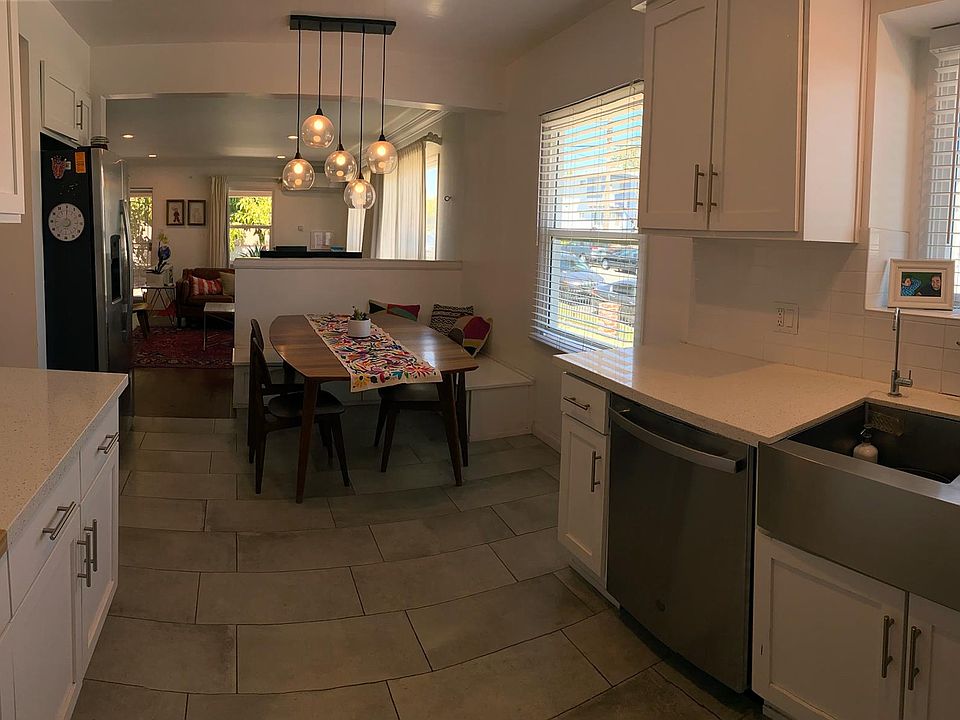 Open space concept kitchen, facing the dining area with sitting nook bench, and living room.