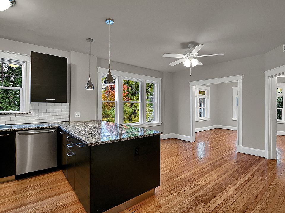 Looking from the Kitchen through the Dining Room into the Family Room - granite bartop peninsula