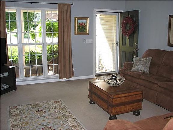 Large living area with fresh paint and large window for tons of natural light.
