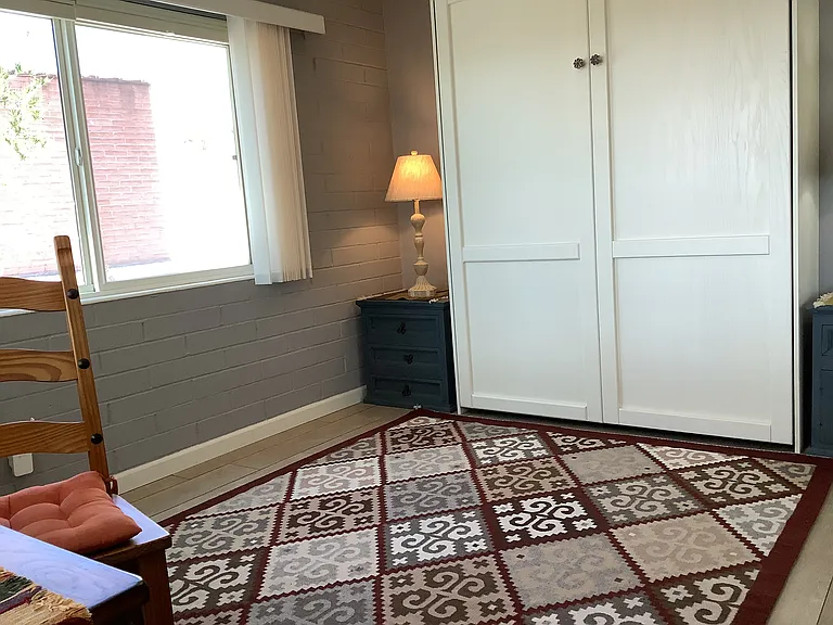 With a a space-saving Murphy bed, a small desk, and built-in closet organizer, when not in use the spare bedroom offers open floor space for stretching and light exercise.