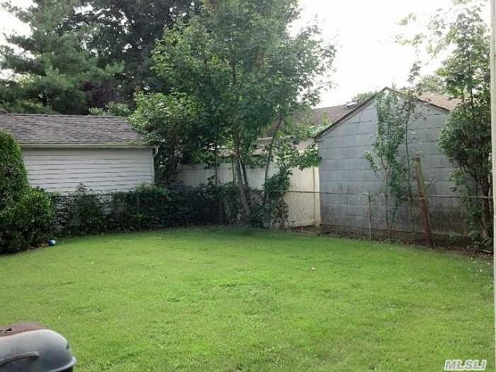 yard has paver BBQ area
