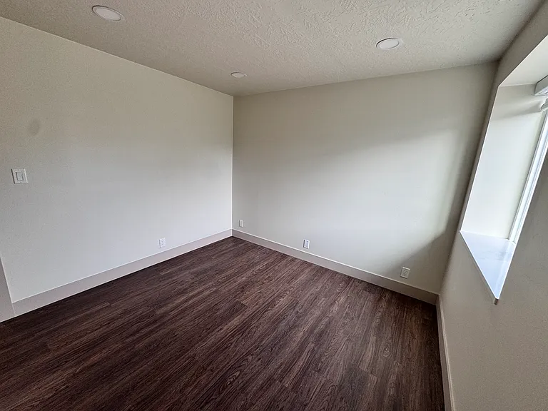Bedroom with abundant natural light and a spacious closet.
