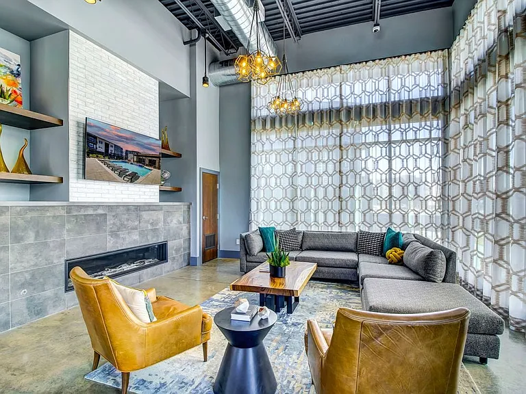 Resident's clubhouse with entertaining kitchenette, flat-screen television, billiards, and more