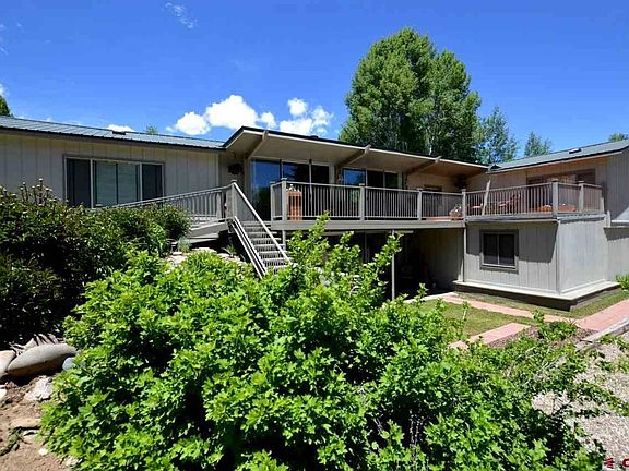 Two levels with upper and lower porches, parking areas and landscaping.