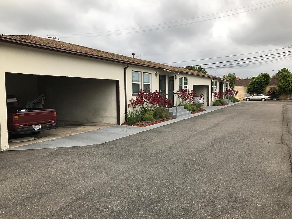 Garden Grove Apartments' exterior with assigned carport parking.