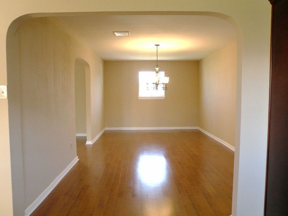 Large dining room with neutral colors and beautiful flooring.