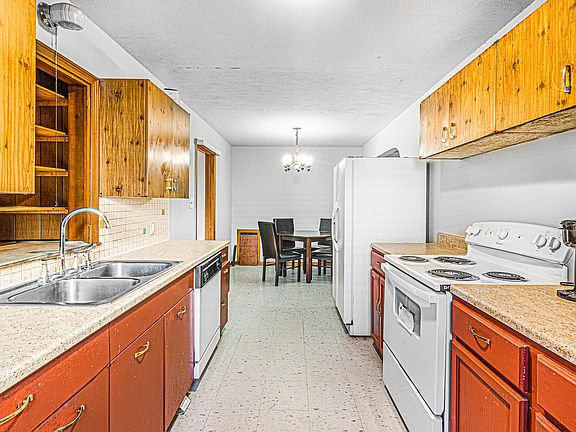 Kitchen in the foreground, dining area in the background. No furniture included, appliances included
