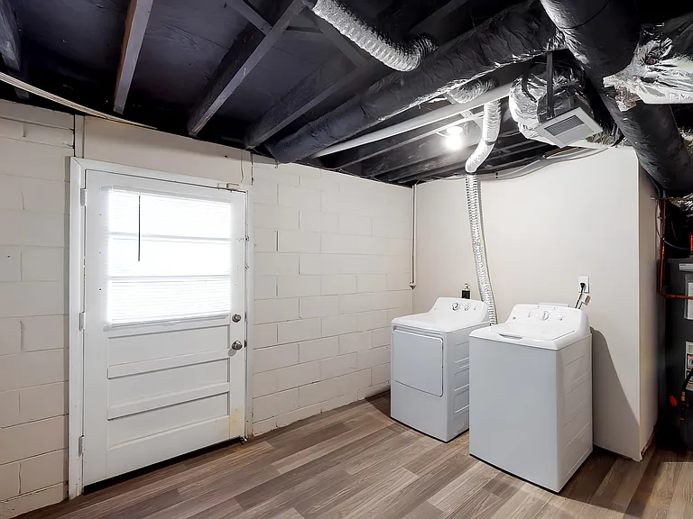 Downstairs laundry, behind the bathroom.