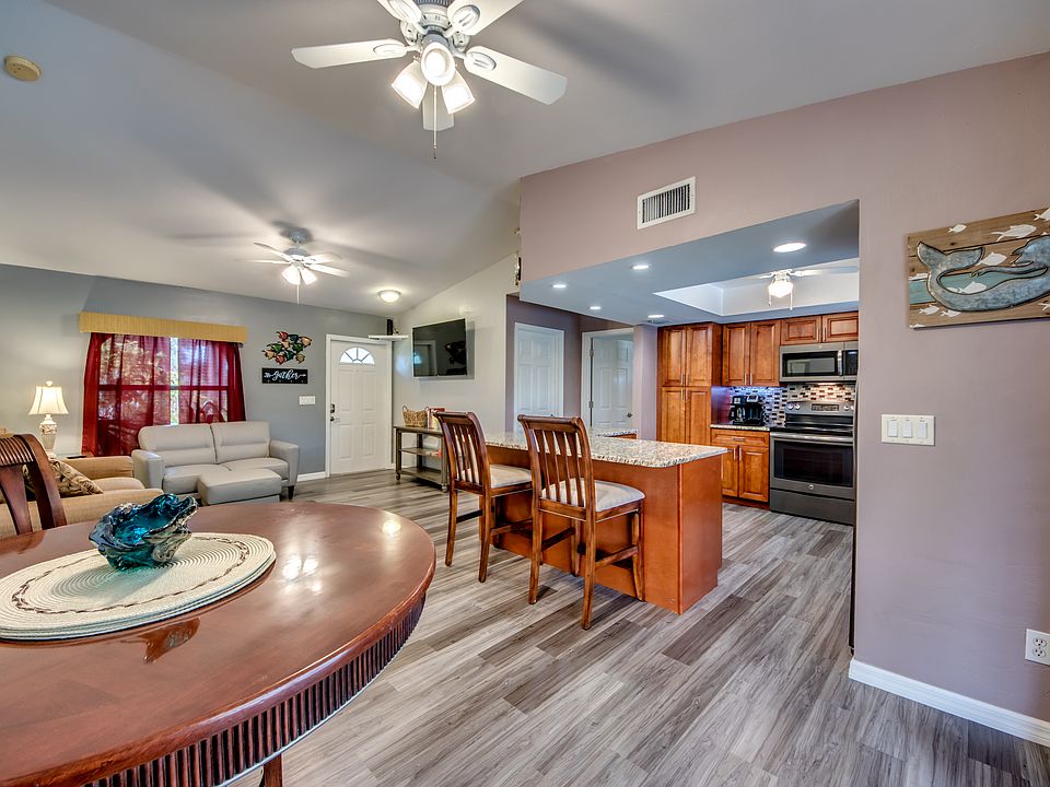Dining, kitchen, and living areas. Door to laundry is to the right of the TV. Laundry also opens to garage.