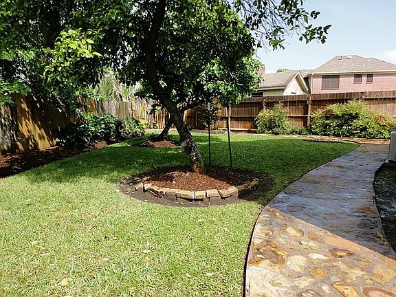 Flagstone pathways throughout yard - gorgeous landscaping - sprinkler system.