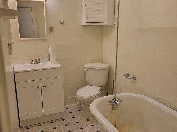 Bathroom with new vanity and flooring. Deep clawfoot tub
